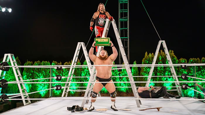 WWE's Otis holds the Money in the Bank briefcase after winning the ladder match